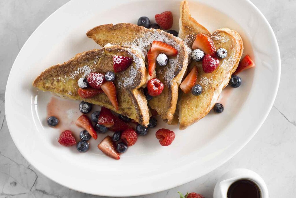 Brio's french toast with fresh fruit and a side of syrup